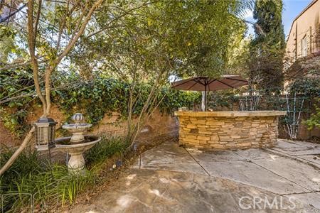 28 Secret Garden Irvine, CA 92620 - Photo 13 of 38 a view of a patio with table and chairs under an umbrella