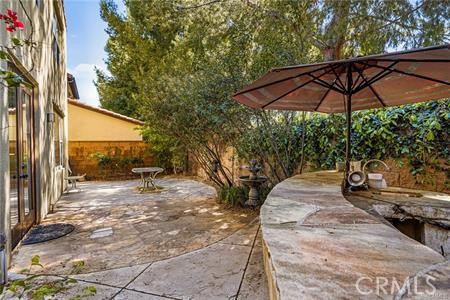 28 Secret Garden Irvine, CA 92620 - Photo 15 of 38 a backyard of a house with table and chairs under an umbrella