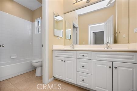 28 Secret Garden Irvine, CA 92620 - Photo 24 of 38 a bathroom with a granite countertop toilet a double vanity sink a mirror and a bathtub