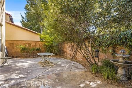 28 Secret Garden Irvine, CA 92620 - Photo 28 of 38 a view of a backyard with table and chairs and wooden fence