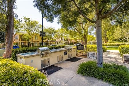 28 Secret Garden Irvine, CA 92620 - Photo 29 of 38 a backyard of a house with barbeque oven table and chairs