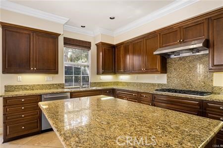 28 Secret Garden Irvine, CA 92620 - Photo 8 of 38 a kitchen with wooden cabinets and a sink
