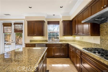 28 Secret Garden Irvine, CA 92620 - Photo 9 of 38 a kitchen with stainless steel appliances granite countertop a sink stove and cabinets