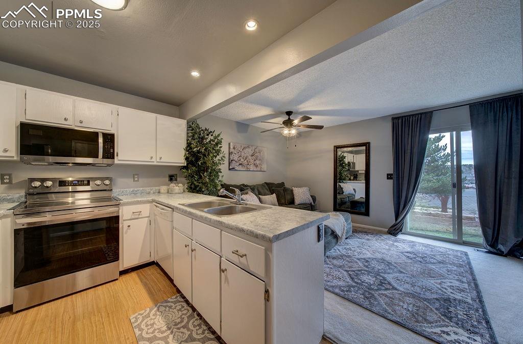 2012 Erin Loop Colorado Springs, CO 80918 - Photo 12 of 48 a large kitchen with granite countertop a stove and a sink