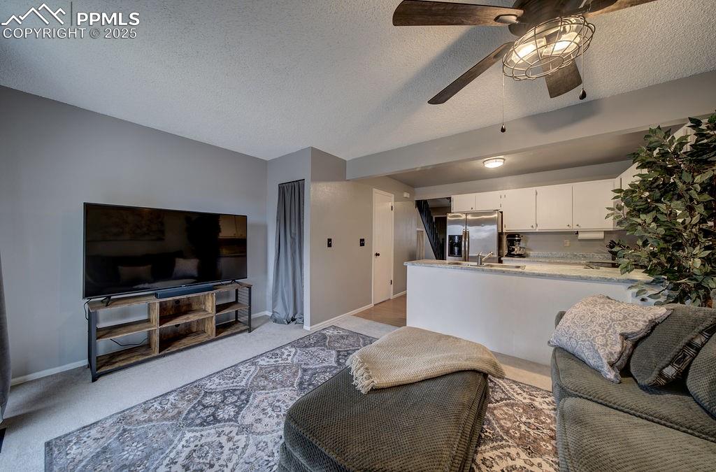 2012 Erin Loop Colorado Springs, CO 80918 - Photo 16 of 48 a living room with furniture and a flat screen tv