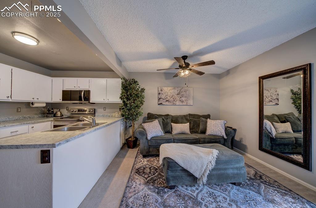 2012 Erin Loop Colorado Springs, CO 80918 - Photo 18 of 48 a living room with furniture and kitchen view