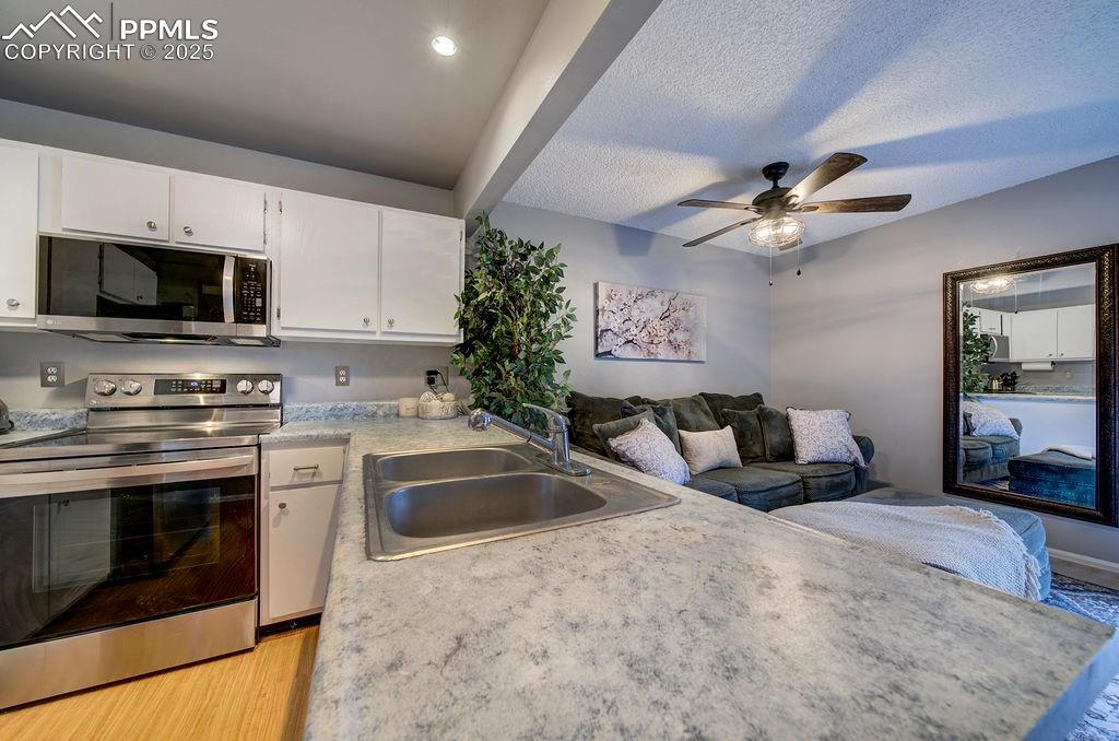 2012 Erin Loop Colorado Springs, CO 80918 - Photo 22 of 48 a kitchen with a stove and a microwave