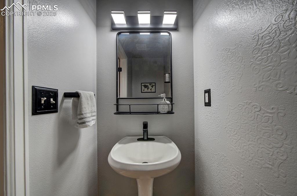 2012 Erin Loop Colorado Springs, CO 80918 - Photo 24 of 48 a bathroom with a sink and a mirror