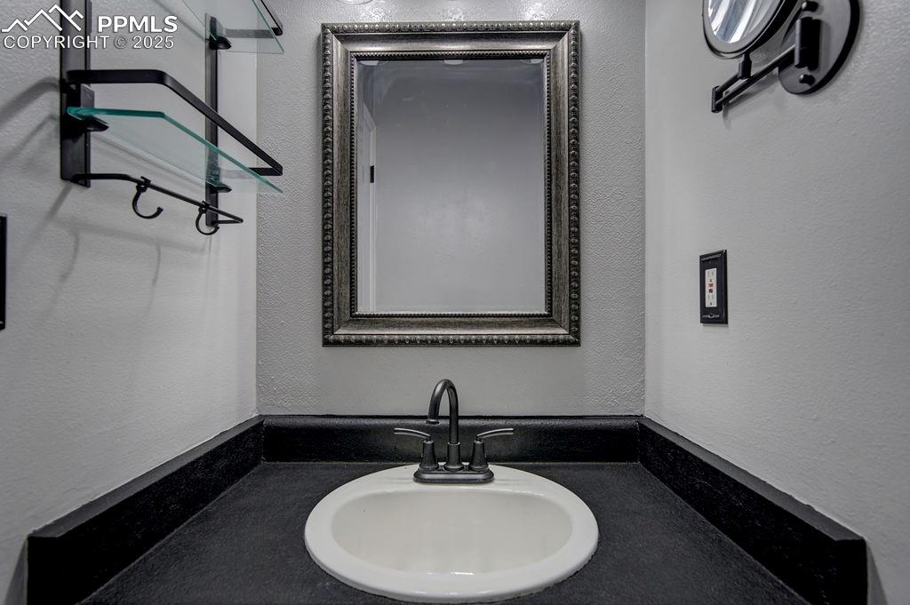 2012 Erin Loop Colorado Springs, CO 80918 - Photo 33 of 48 a bathroom with a sink and a mirror