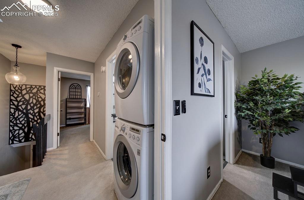 2012 Erin Loop Colorado Springs, CO 80918 - Photo 35 of 48 a view of a hallway with washer and dryer