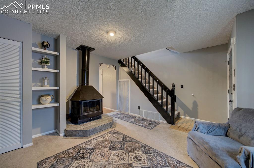 2012 Erin Loop Colorado Springs, CO 80918 - Photo 9 of 48 a living room with furniture and a fireplace