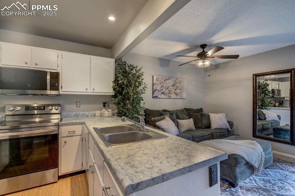 2012 Erin Loop Colorado Springs, CO 80918 - Photo 10 of 48 a kitchen with a stove a sink and a microwave