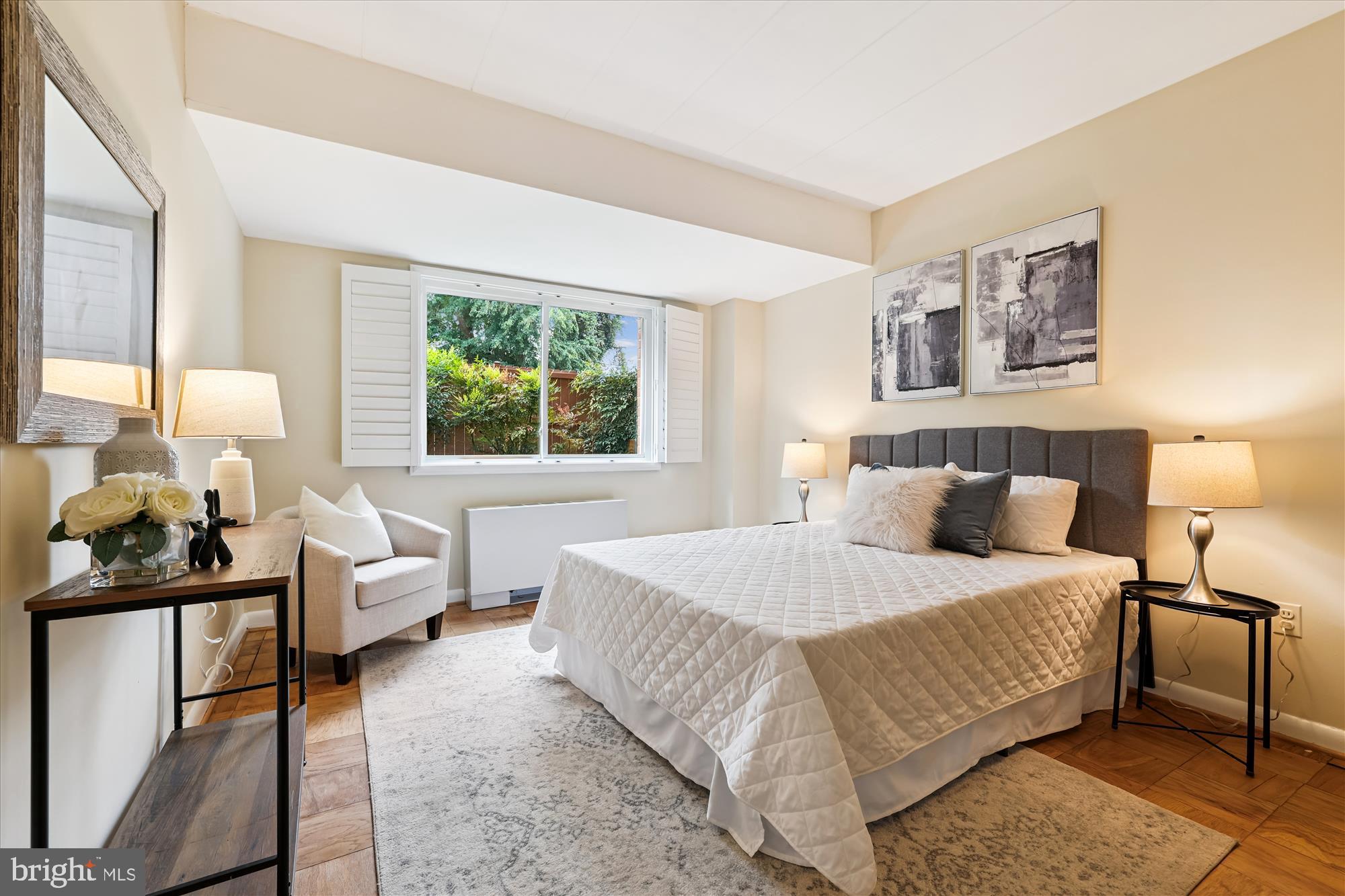 4800 Chevy Chase Drive, Unit 101 Chevy Chase, MD 20815 - Photo 11 of 17 a bedroom with a bed and wooden floor