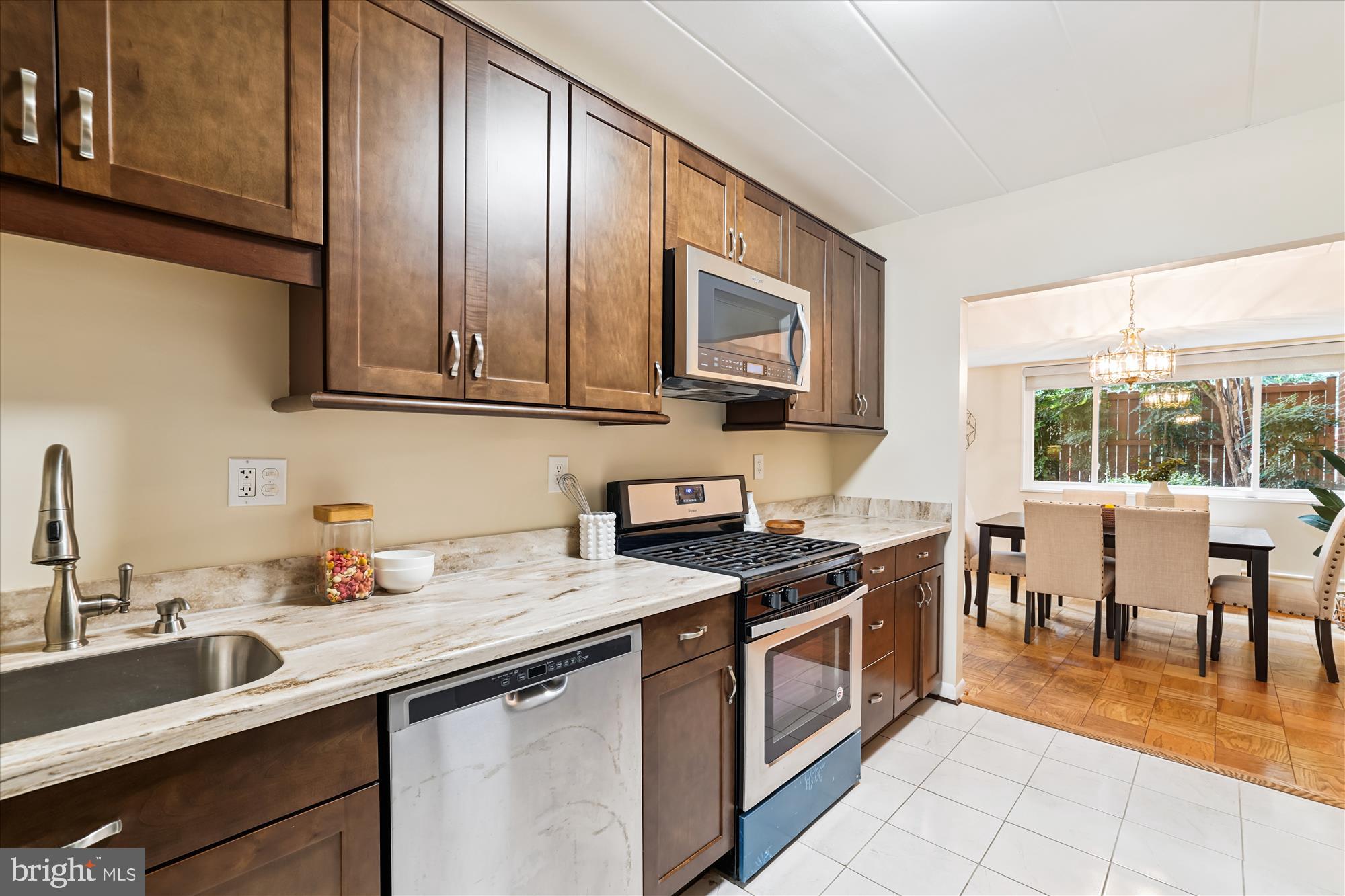 4800 Chevy Chase Drive, Unit 101 Chevy Chase, MD 20815 - Photo 5 of 17 a kitchen with stainless steel appliances granite countertop a sink stove and cabinets