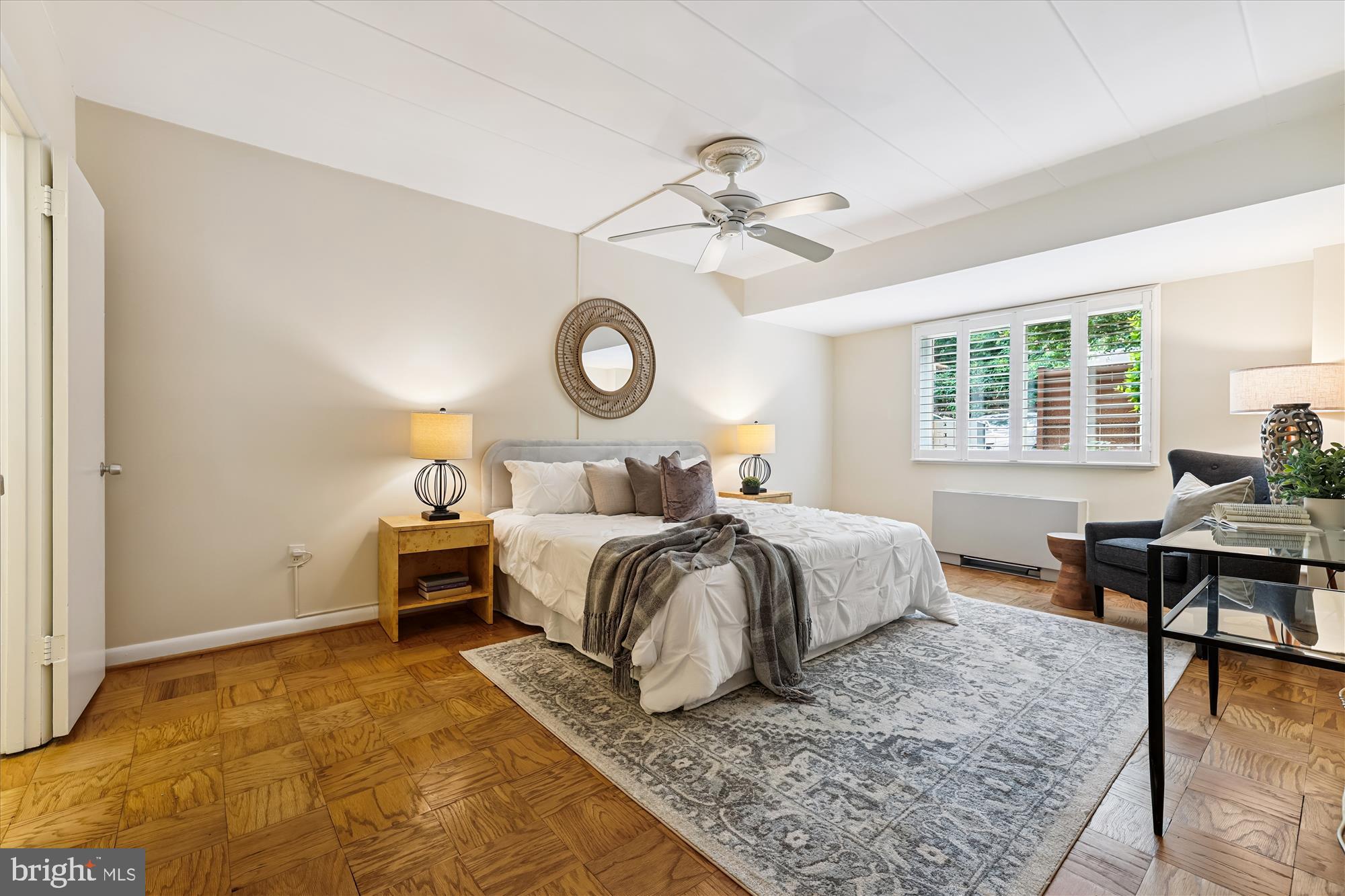 4800 Chevy Chase Drive, Unit 101 Chevy Chase, MD 20815 - Photo 7 of 17 a bedroom with a bed a table and chair