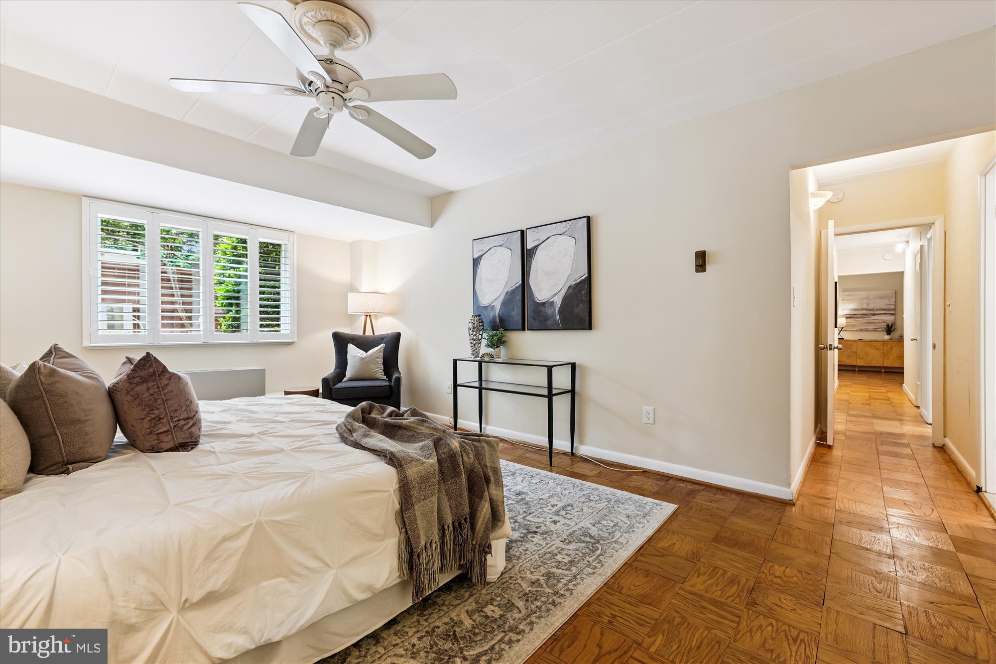 4800 Chevy Chase Drive, Unit 101 Chevy Chase, MD 20815 - Photo 8 of 17 a bedroom with a bed and wooden floor