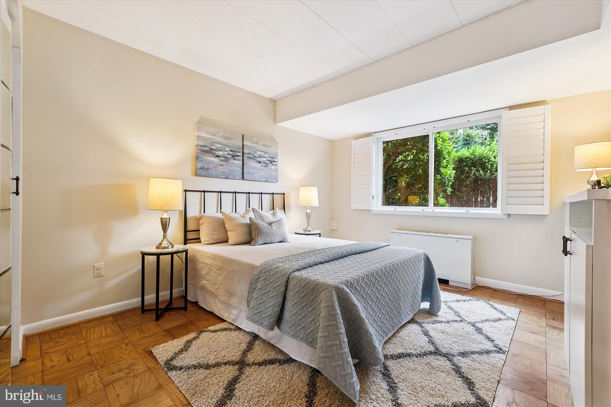 4800 Chevy Chase Drive, Unit 101 Chevy Chase, MD 20815 - Photo 10 of 17 a bedroom with a bed and a window