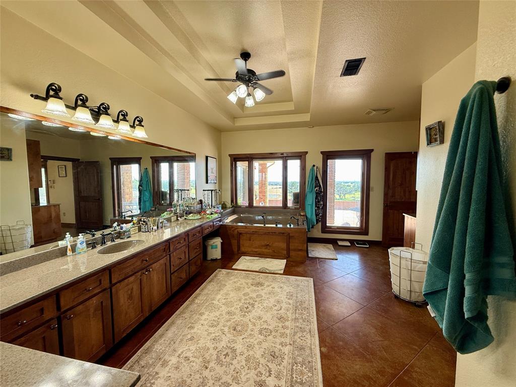 12300 County Road 367 May, TX 76857 - Photo 12 of 40 a large living room with a large bed a chandelier and dresser