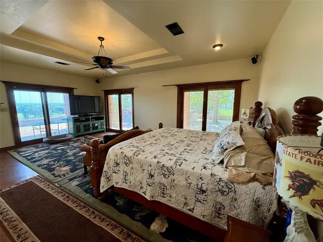 a bed sitting in a spacious bedroom next to a window