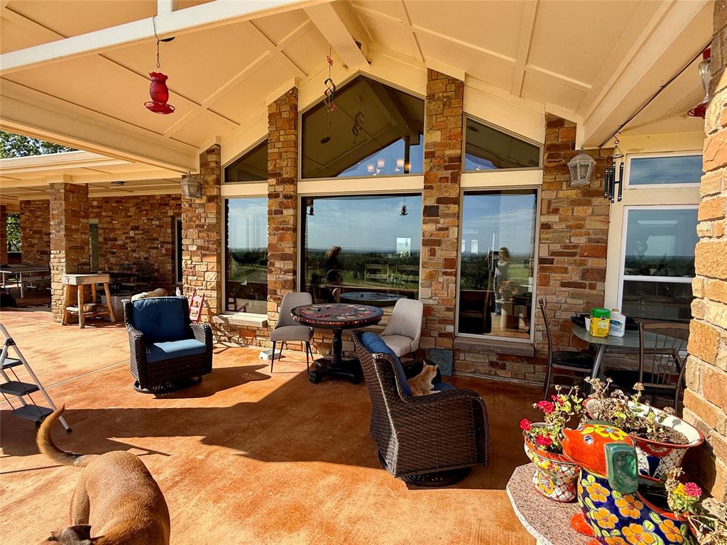 12300 County Road 367 May, TX 76857 - Photo 17 of 40 a living room with patio furniture and a floor to ceiling window