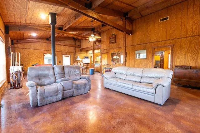 a living room with furniture and a chandelier