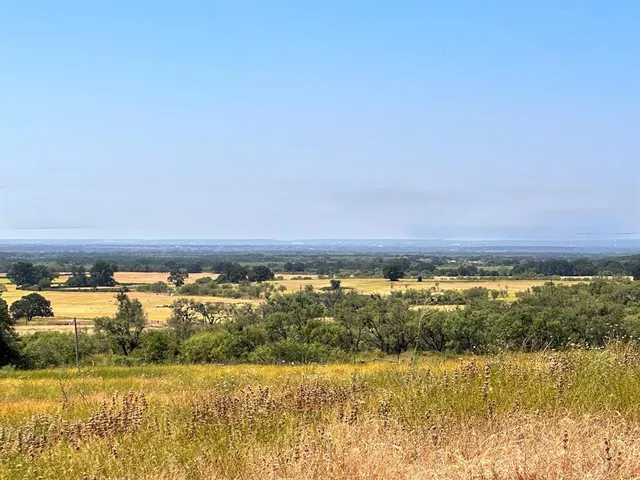 a view of a terrace with lawn chairs