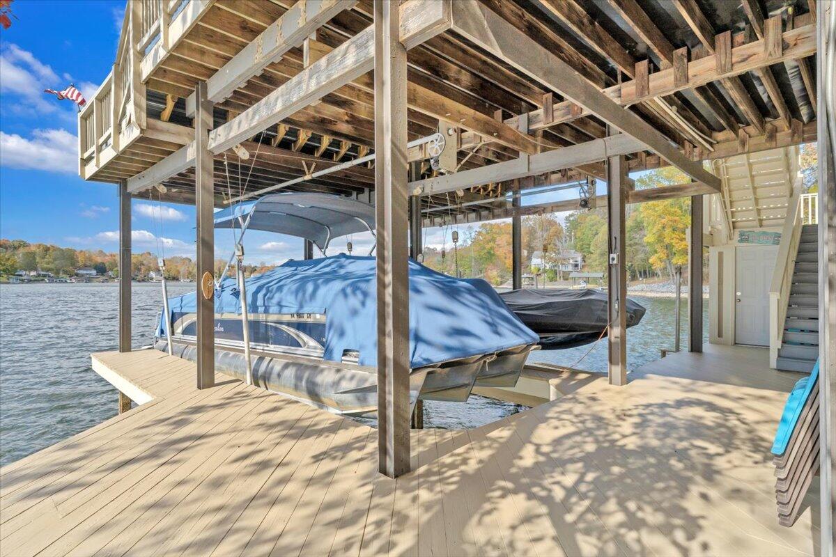 6641 Horseshoe Bend Road Goodview, VA 24095 - Photo 132 of 181 a view of a patio with a table chairs and wooden fence
