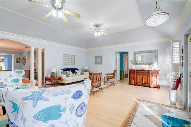 a spacious bedroom with two bed and a chandelier