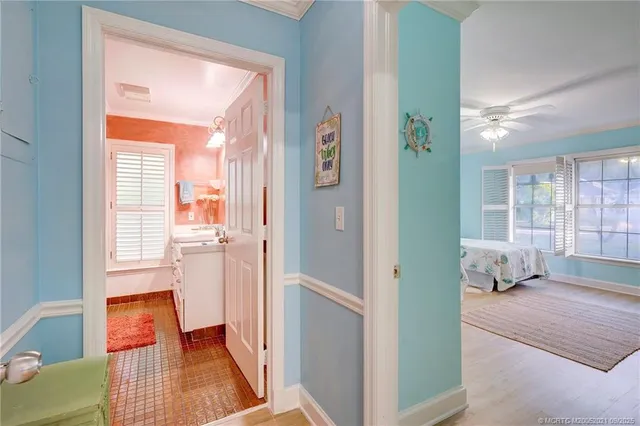 a bathroom with a sink and a mirror with painted walls