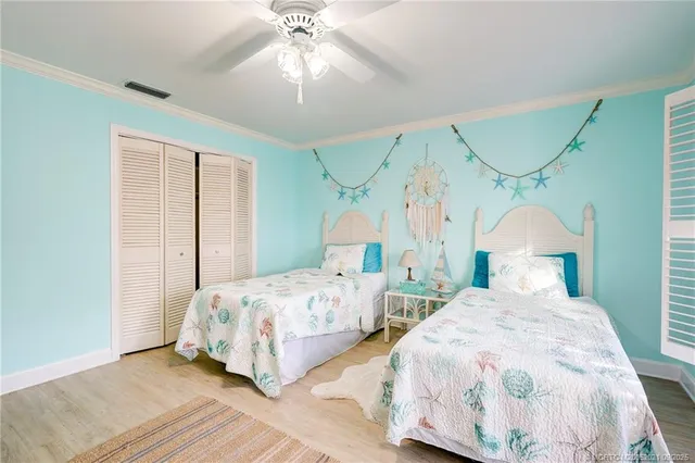 a dining room with furniture a chandelier and wooden floor
