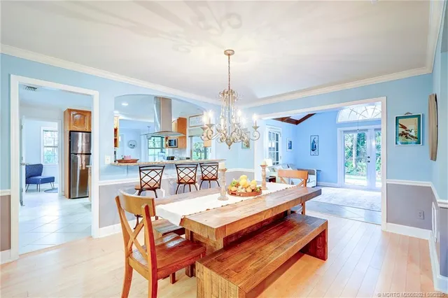 a kitchen with stainless steel appliances granite countertop a table and chairs in it