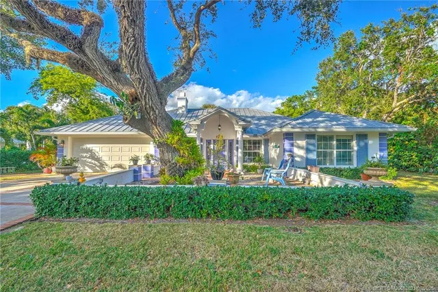 a front view of a house with garden and porch