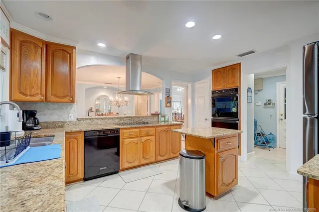 a bedroom with a bed a dresser and a large window