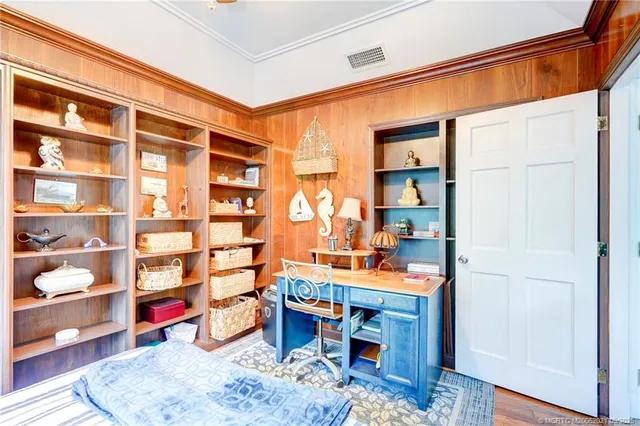 a view of a room that has a bed and a chandelier