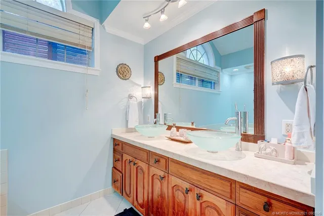 a front view of a house with garden and sitting area