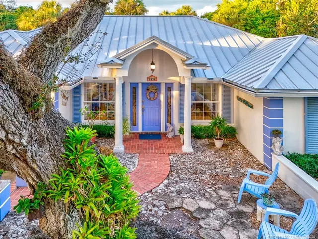 a living room with fireplace furniture and a chandelier
