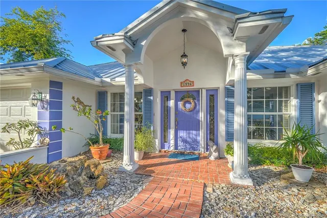 a living room with furniture chandelier and a view of kitchen