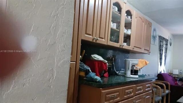 a kitchen with stainless steel appliances granite countertop a stove and cabinets