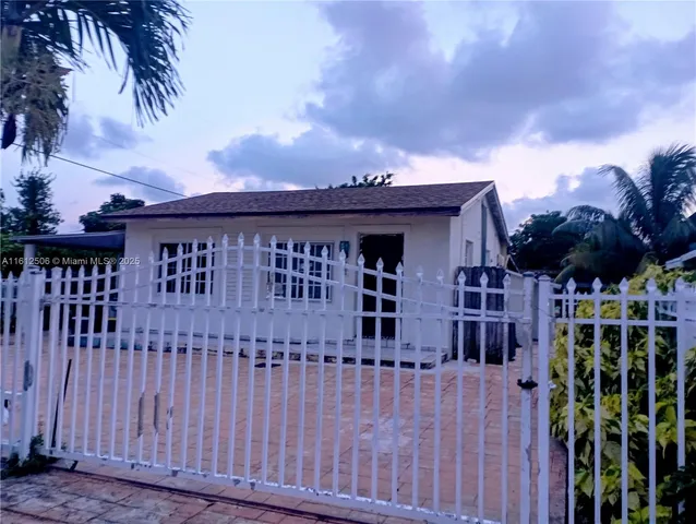 a view of a house with a small yard and plants