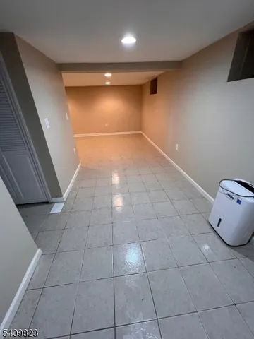 a view of an empty room and wooden floor