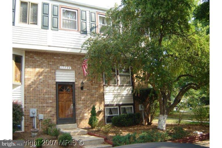 a front view of a house with tree s