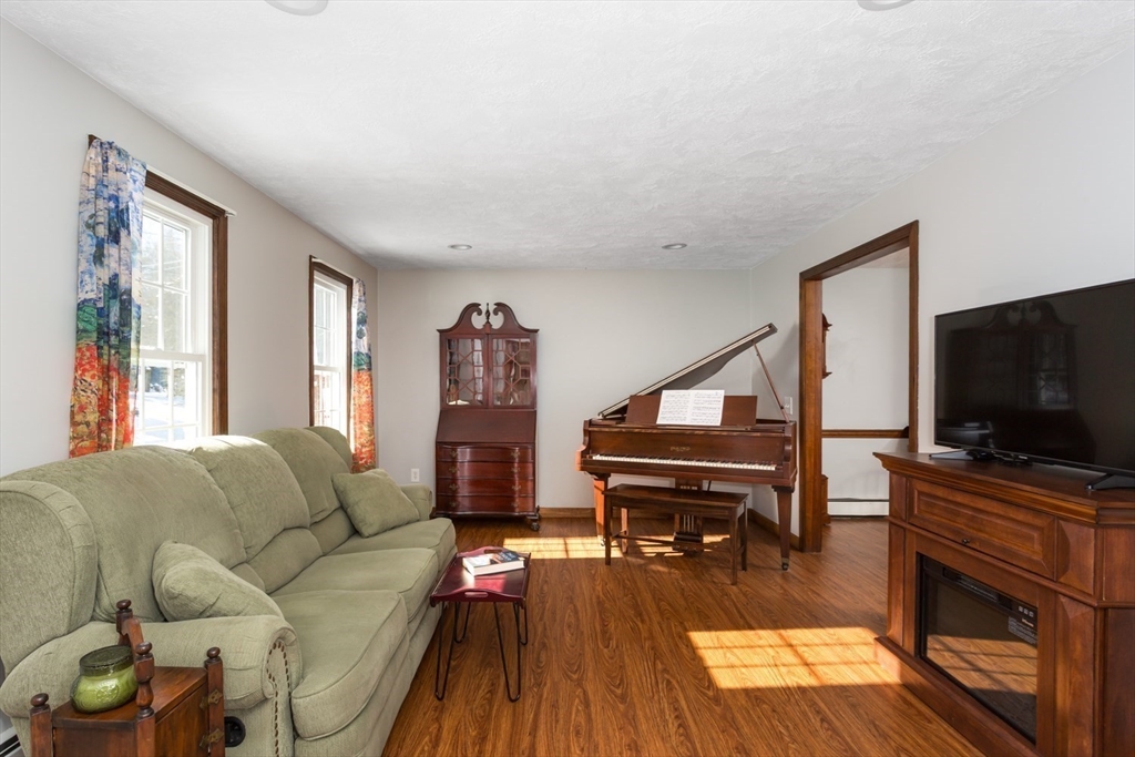75 Jordan Road Franklin, MA 02038 - Photo 13 of 46 a living room with furniture and a flat screen tv with wooden floor