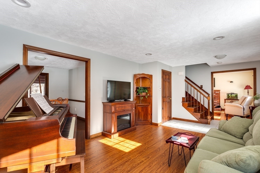 75 Jordan Road Franklin, MA 02038 - Photo 14 of 46 a living room with furniture a flat screen tv and a refrigerator
