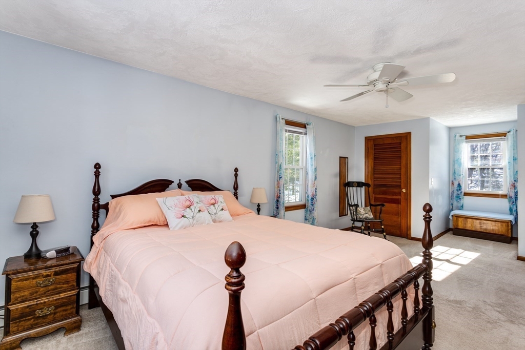 75 Jordan Road Franklin, MA 02038 - Photo 18 of 46 a bedroom with a bed and a chandelier