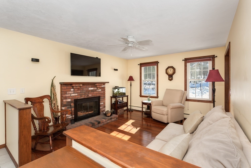 75 Jordan Road Franklin, MA 02038 - Photo 3 of 46 a living room with furniture a flat screen tv and a fireplace