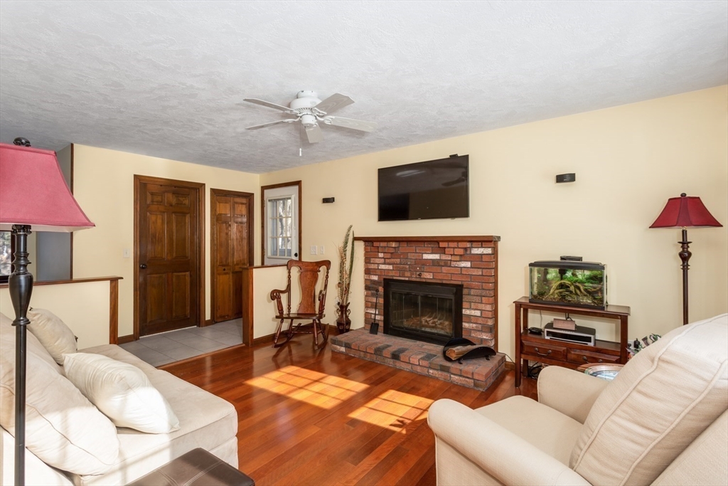 75 Jordan Road Franklin, MA 02038 - Photo 10 of 46 a living room with furniture a flat screen tv and a fireplace