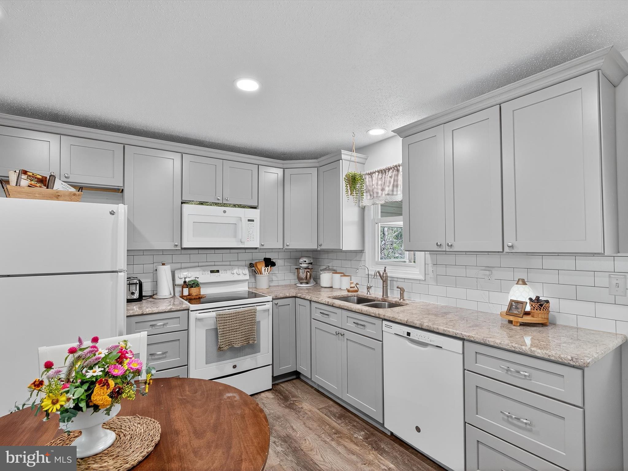 351 North Colebrook Road Manheim, PA 17545 - Photo 11 of 32 a kitchen with a sink white cabinets and white appliances