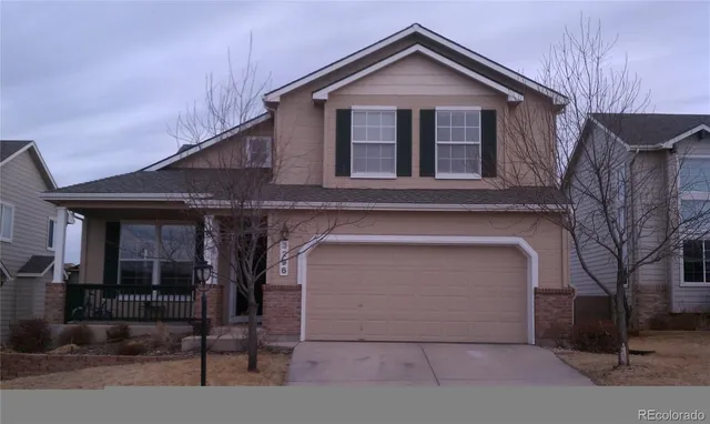 a front view of a house with garage