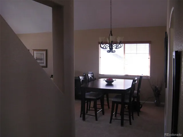 a view of a dining room with furniture and window