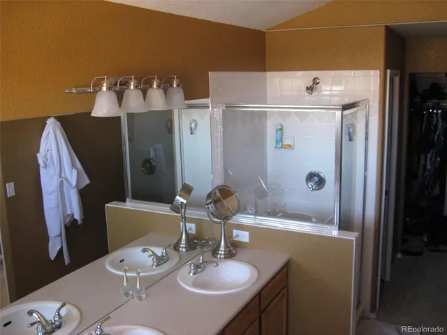 a bathroom with a sink mirror and vanity